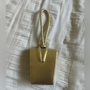 Shiny gold fabric clutch purse.